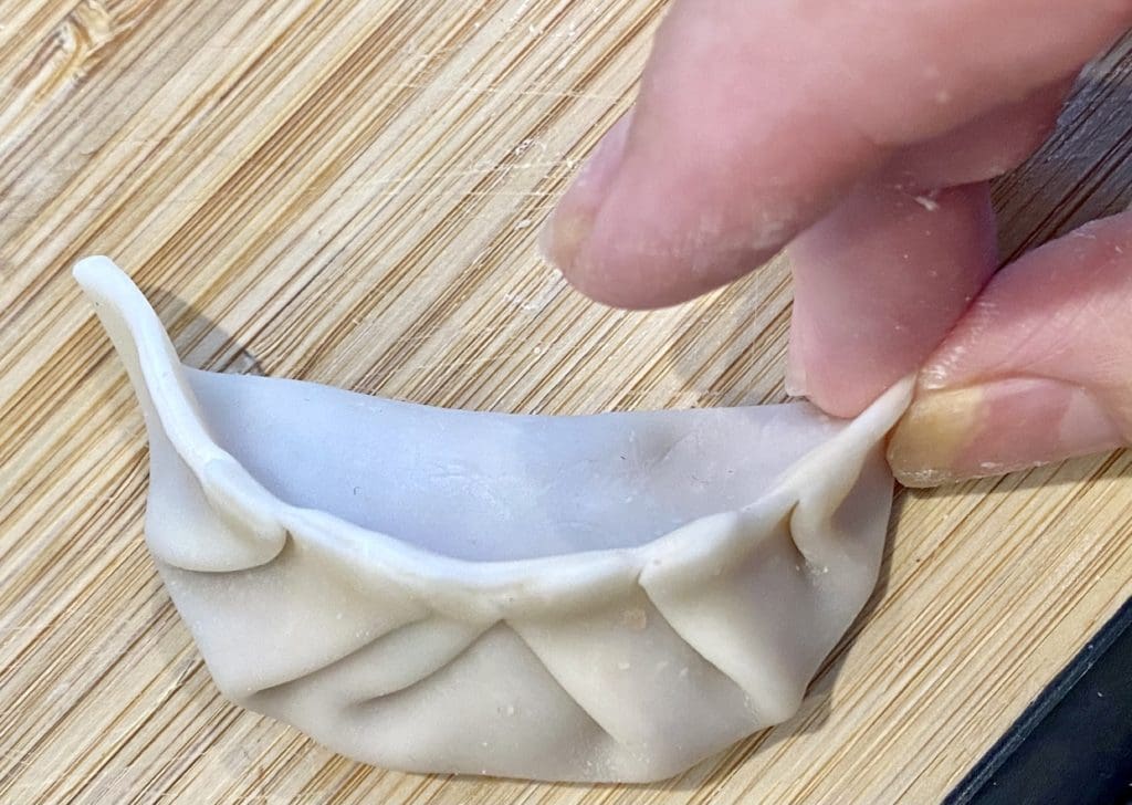 pleating pork and prawn potstickers