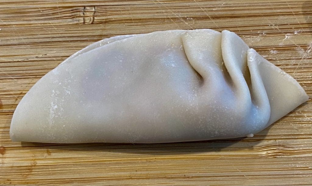 pleating pork and prawn potstickers