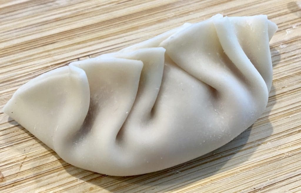 pleating pork and prawn potstickers
