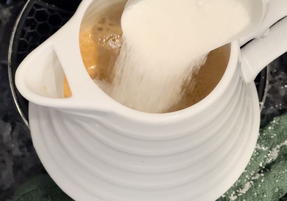 mixing coffee into cream