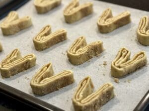 Neatly sliced palmiers on a tray ready to bake