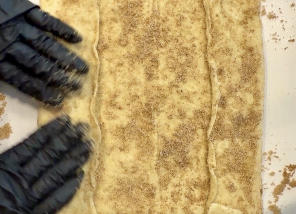 The initial stages of folding a puff pastry into a log