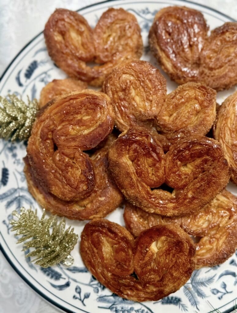 A plate full of crispy brown sugar palmiers